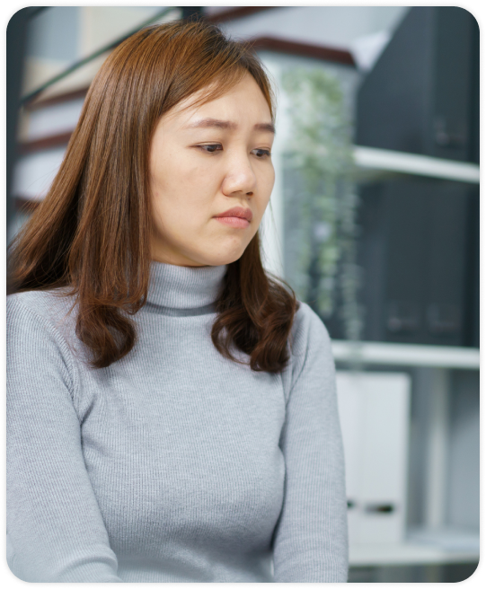 A woman looks sad as if she has been wrongfully terminated.